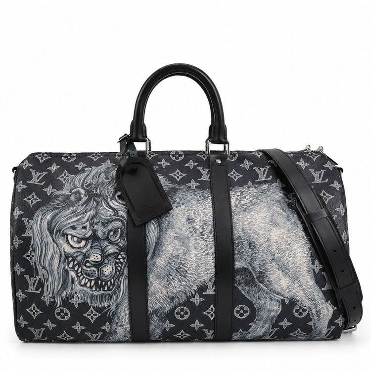 Louis Vuitton Chapman Brothers Keepall 55 Bandouliere travel bag in navy with lion print, featuring leather handles and adjustable strap.