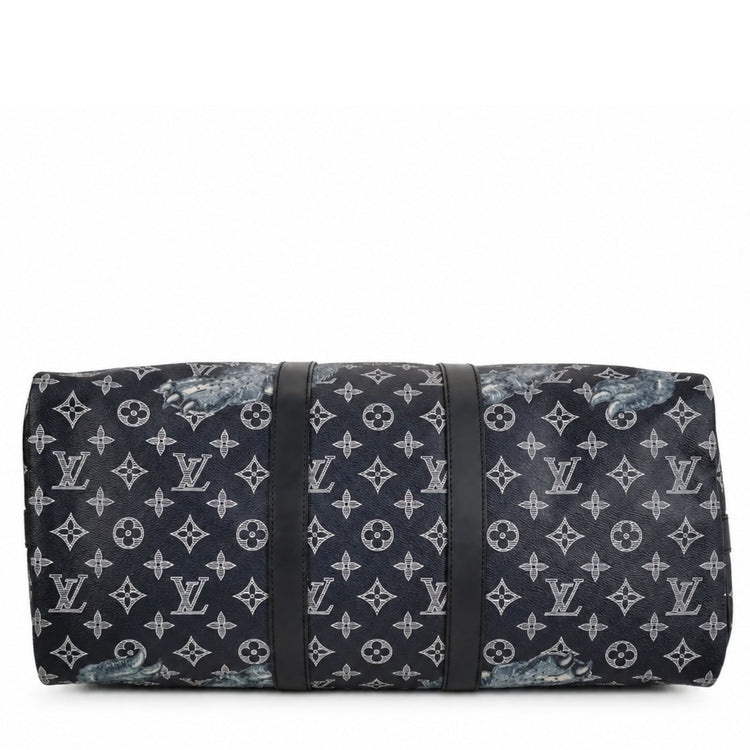 Louis Vuitton Chapman Brothers Keepall 55 Bandouliere travel bag in navy with lion design, featuring sturdy handles and shoulder strap.