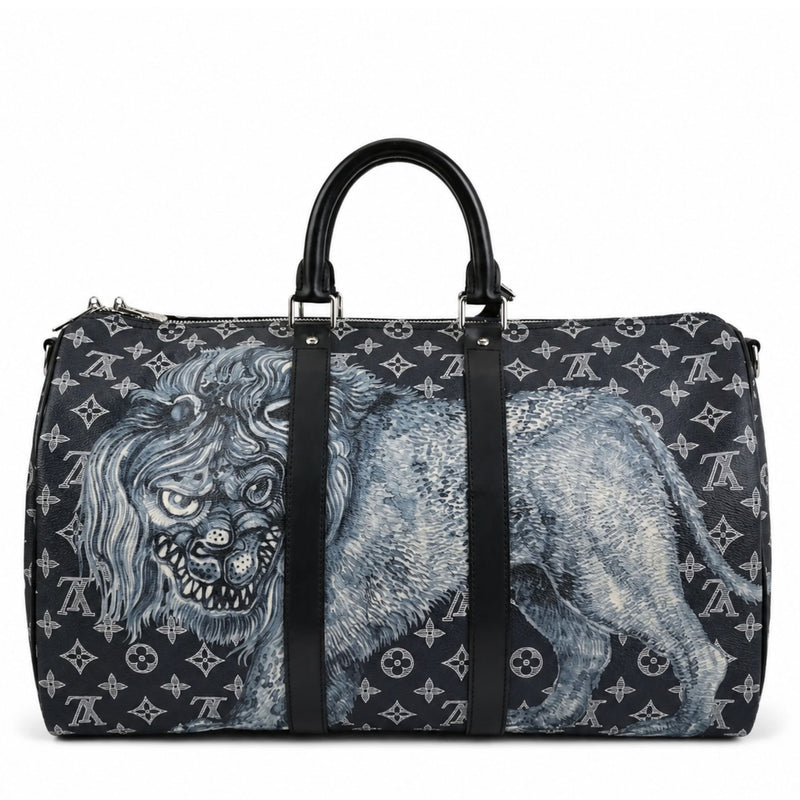 Louis Vuitton Chapman Brothers Keepall 55 Bandouliere travel bag in navy with lion design, featuring leather handles and adjustable strap.