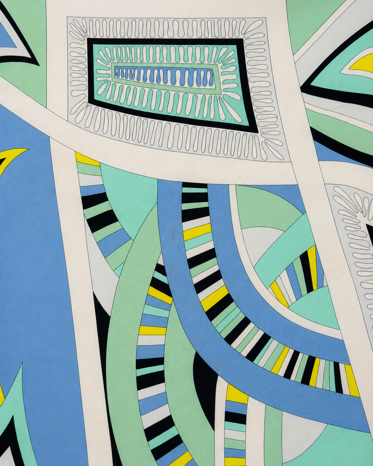 Emilio Pucci abstract print slip dress with vibrant, colorful patterns and flowing fabric, displayed on a mannequin.