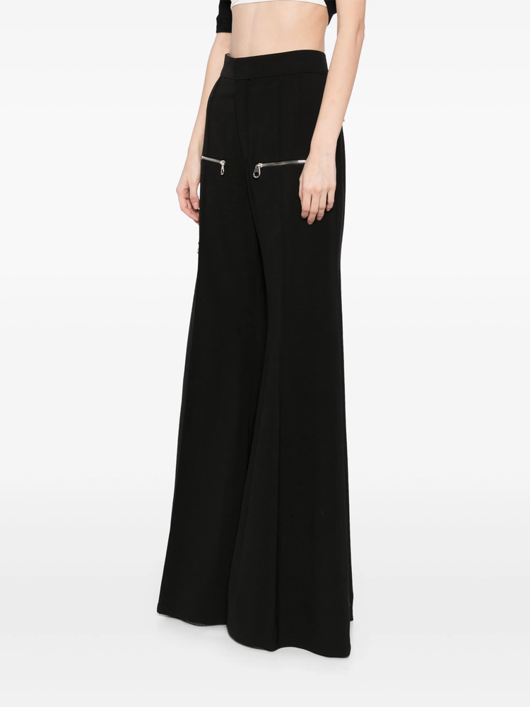Chloé flared zip trousers featuring high waist and wide-leg design, shown in a stylish fabric with front zipper detail.