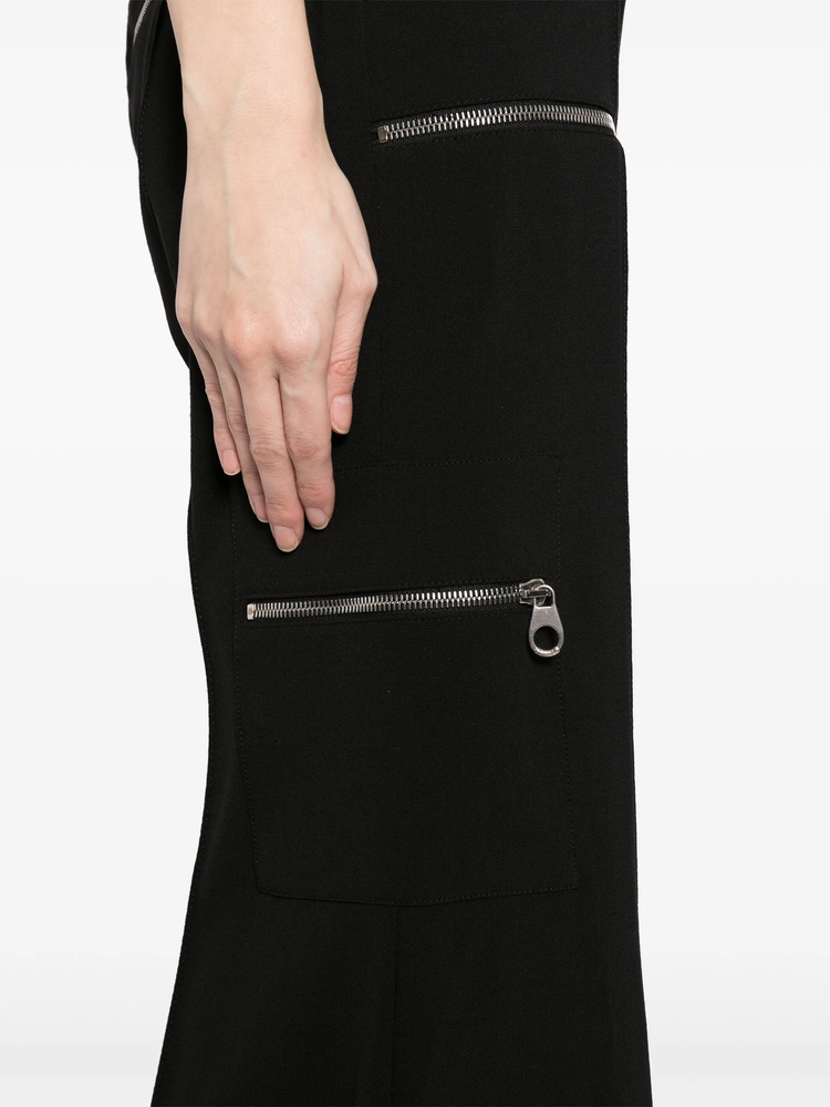 Chloé flared zip trousers in black fabric with high waist, front zipper detail, and wide-leg style, shown on a model.