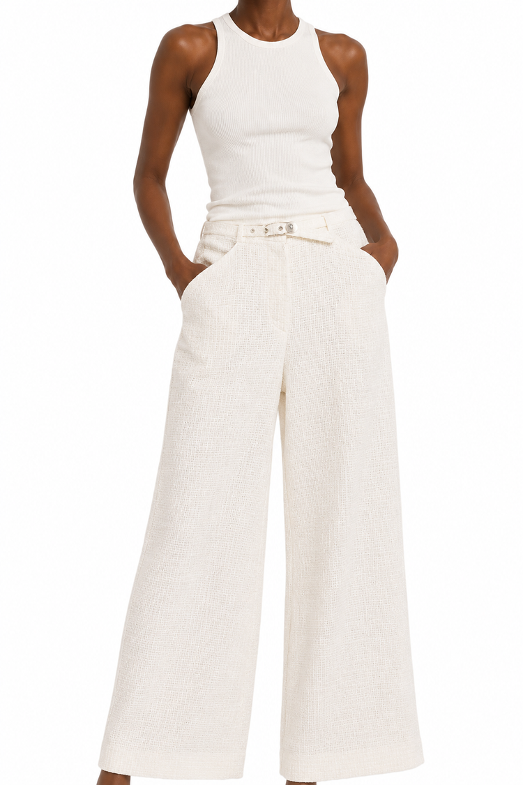 Cream Chanel tweed trousers with tailored fit and classic texture, showcased in a stylish close-up image.