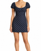 Dior dark navy polka dot dress with cream spots, scoop neckline, short puff sleeves and an empire-style fitted silhouette.