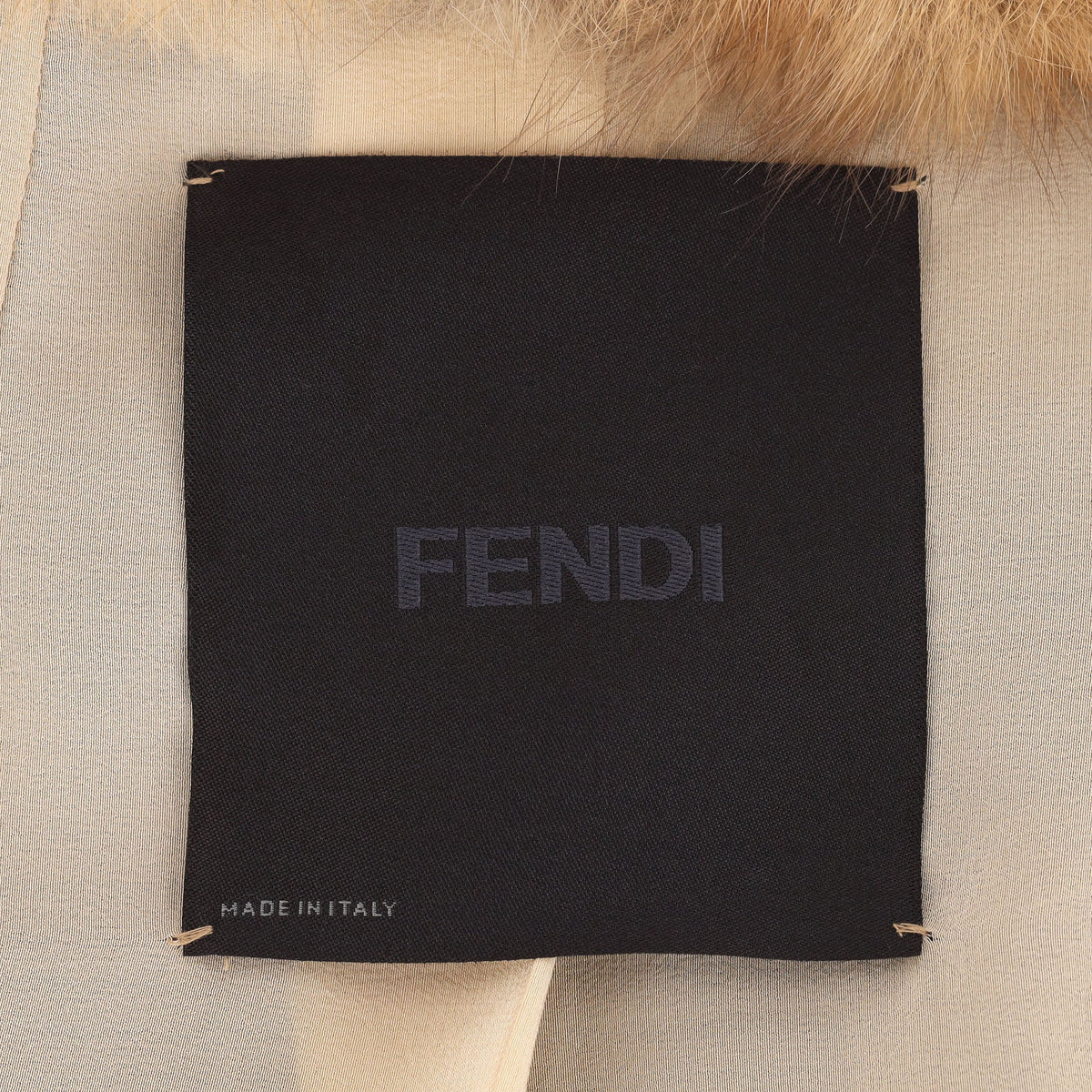 Fendi beige and brown hooded fur gilet with plush texture, sleeveless longline silhouette, rounded shoulders and vertical panel detailing.