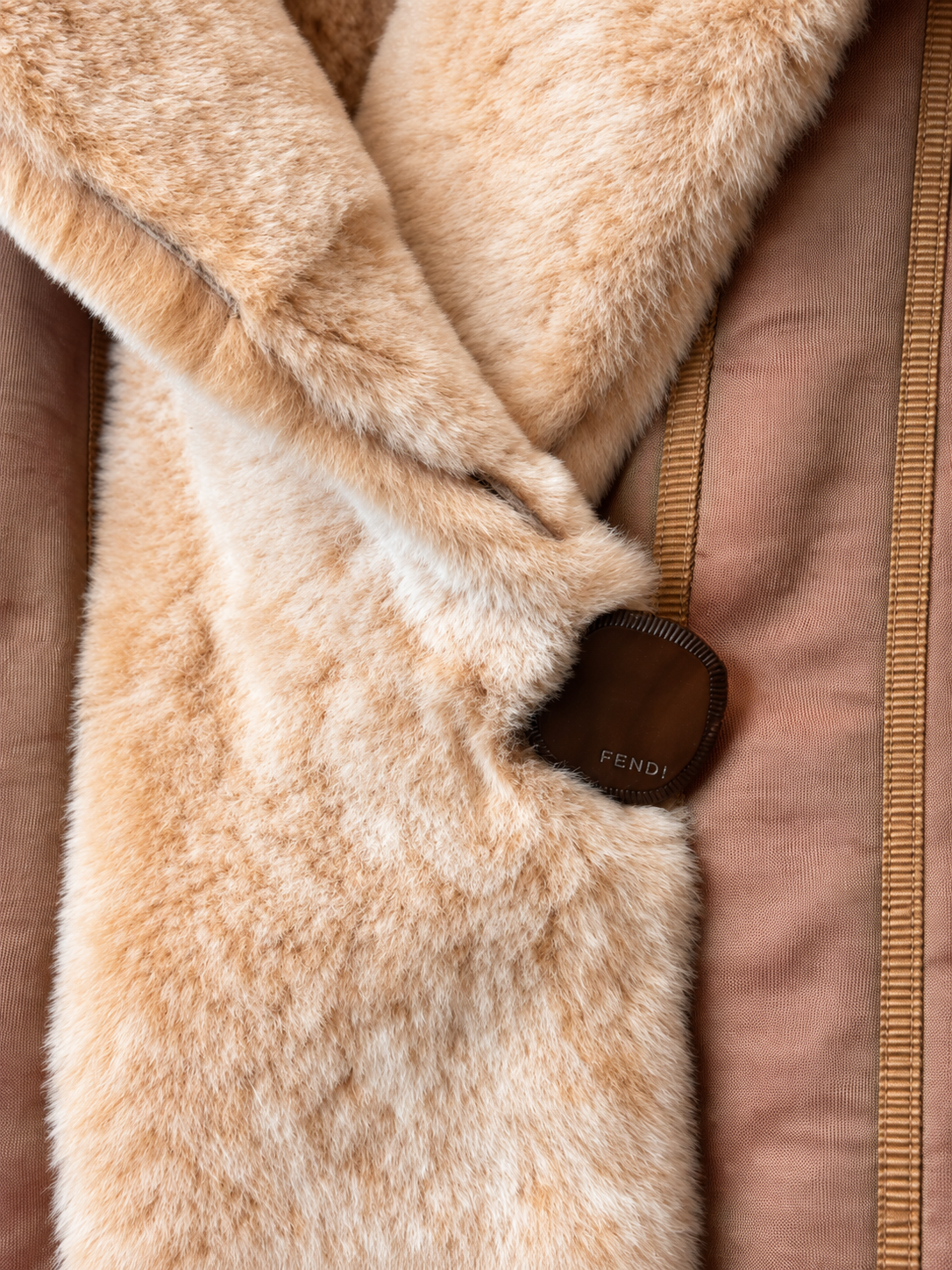Close-up of Fendi sheared mink fur reversible coat showing fastening details and luxurious texture.