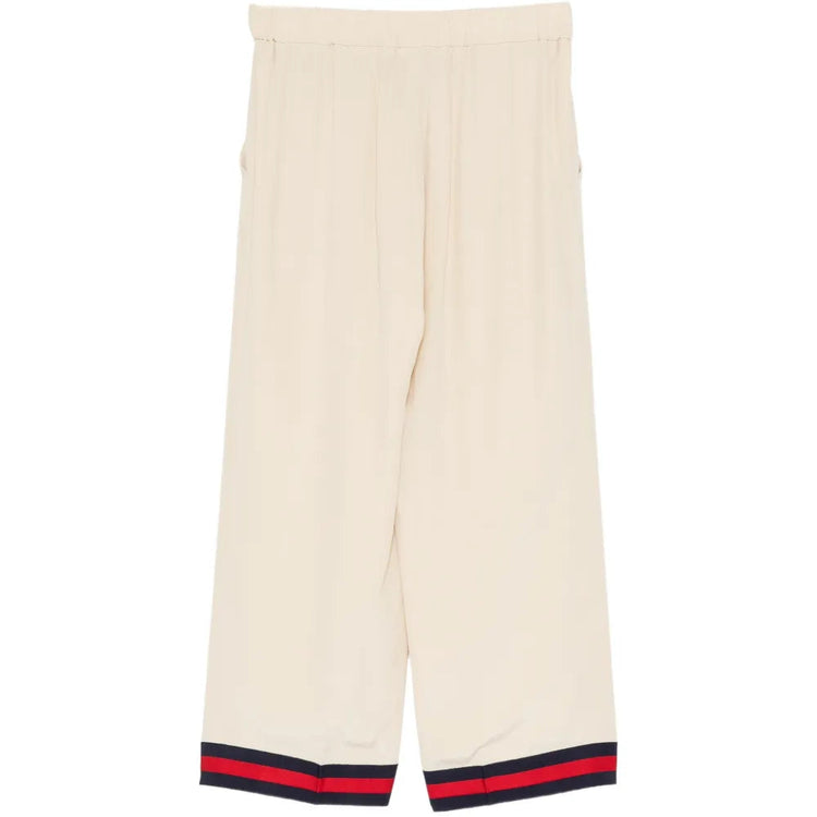 Gucci silk wide-leg trousers shown on a model with a smooth, flowing fabric and elegant design.