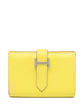 Hermès Bearn yellow card holder wallet with multiple card slots and sleek design, made from premium leather.