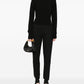 Hermès black riding trousers with a tailored fit, featuring sleek fabric and classic styling for equestrian or casual wear.