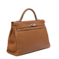 Hermès Kelly 40 Gold PHW top handle bag with structured silhouette and gold hardware, featuring a sleek, luxurious design.