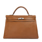 Hermès Kelly 40 Gold PHW top handle bag featuring smooth leather and elegant gold hardware.