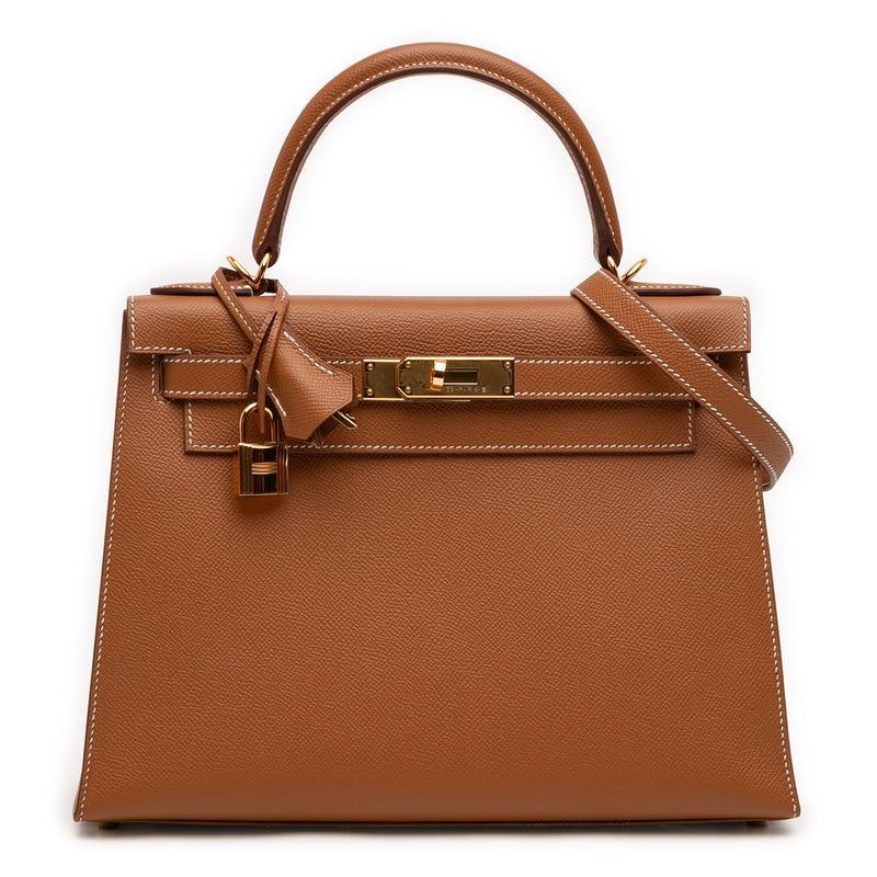 Hermès Kelly II Sellier 28 bag in Gold Epsom leather with gold-tone hardware, white contrast stitching, rolled top handle, detachable shoulder strap, front flap, belted straps, clochette, and padlock.