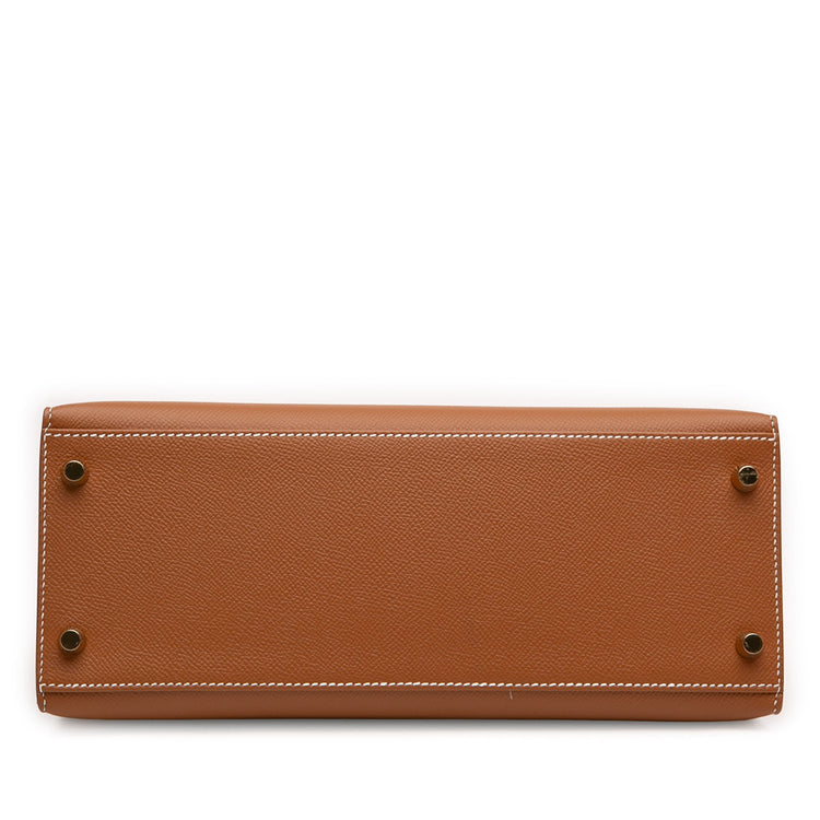 Hermès Kelly II Sellier 28 bag in Gold Epsom leather with gold-tone hardware, white contrast stitching, rolled top handle, detachable shoulder strap, front flap, belted straps, clochette, and padlock.