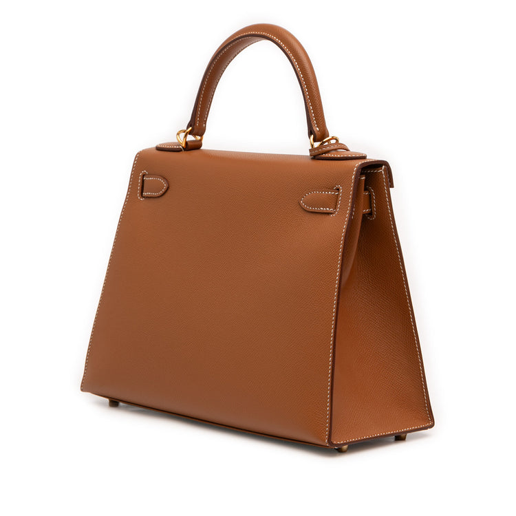 Hermès Kelly II Sellier 28 bag in Gold Epsom leather with gold-tone hardware, white contrast stitching, rolled top handle, detachable shoulder strap, front flap, belted straps, clochette, and padlock.