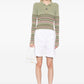 Hermès pleated white Bermuda shorts for women, featuring a tailored fit and classic style, shown on a model.