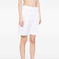 Hermès pleated white Bermuda shorts for women, showcasing tailored design and crisp fabric, perfect for casual or summer wear.