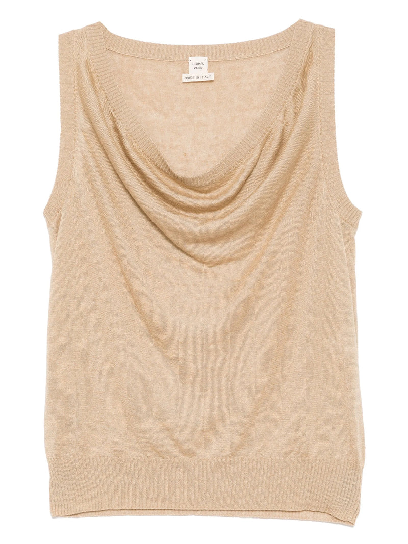 Hermès beige knit vest, cozy sleeveless top made of soft knit fabric, styled as a stylish and comfortable fashion piece.