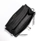 Hermès Kelly Pochette in black Swift leather, showing the interior of the elegant handbag with gold hardware accents.