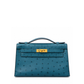 Hermès Kelly Pochette Bleu Colvert ostrich leather top handle bag with gold hardware, showcasing its elegant design and luxurious texture.