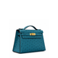 Hermès Kelly Pochette Bleu Colvert ostrich leather top handle bag with gold hardware, showcasing its elegant design and luxurious texture.