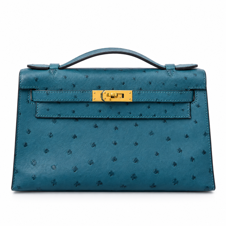 Hermès Kelly Pochette in Bleu Colvert ostrich leather with gold hardware, showcasing elegant handbag design and craftsmanship.