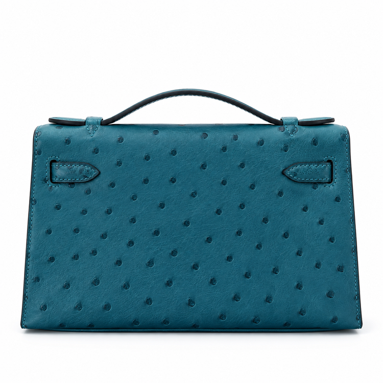 Hermès Kelly Pochette in Bleu Colvert ostrich leather with gold hardware, showcasing a luxurious handbag with elegant stitching and texture.