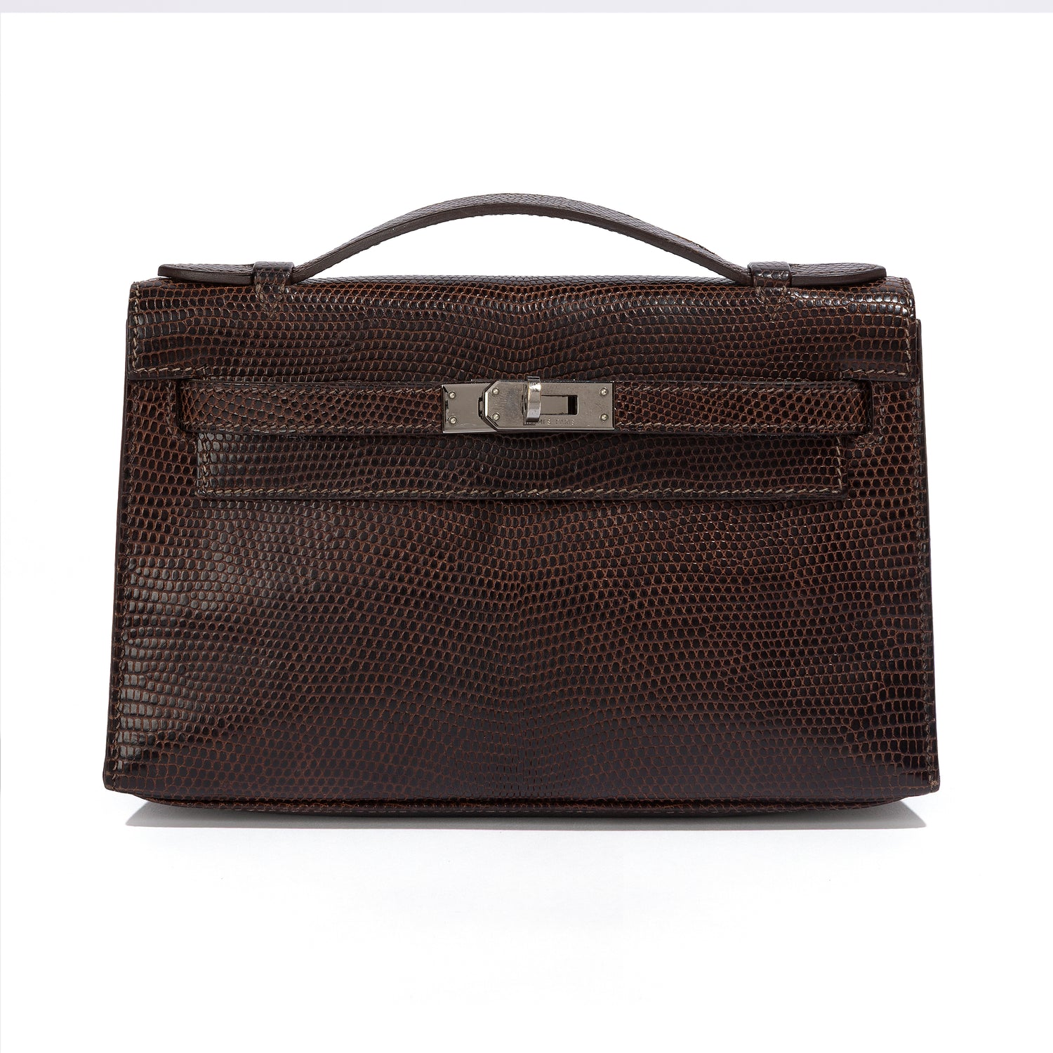 Hermès Chocolat Niloticus Lizard Kelly Pochette handbag with sleek design and elegant leather details.