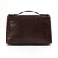 Hermès Chocolat Niloticus lizard Kelly Pochette handbag showing the back view with luxurious chocolate-colored leather and elegant design.