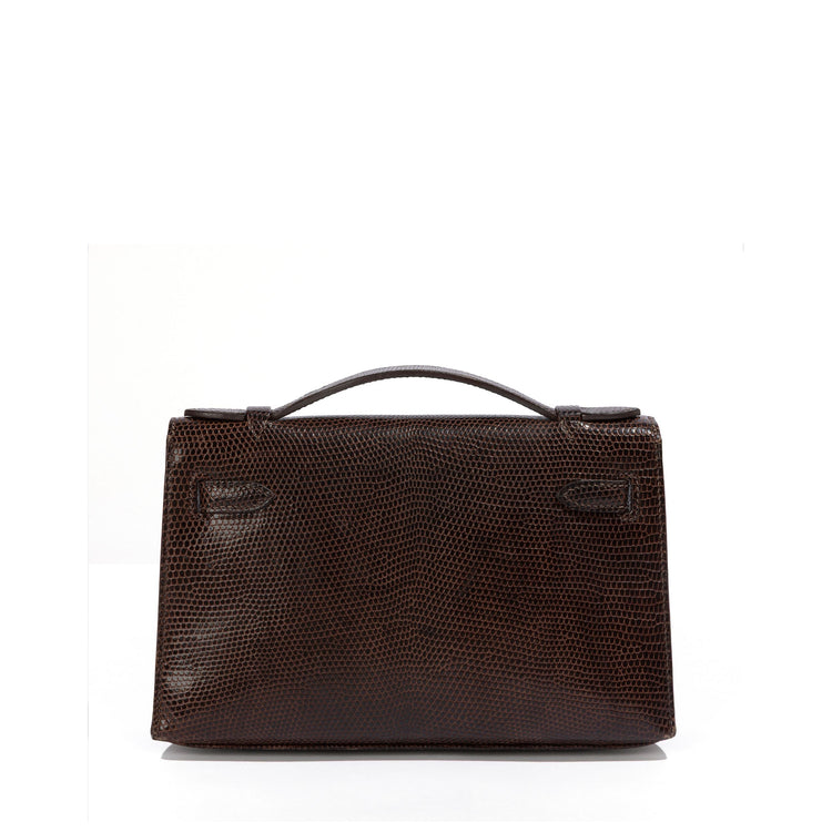 Hermès Chocolat Niloticus Lizard Kelly Pochette handbag with sleek design and elegant leather details.