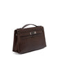 Hermès Chocolat Niloticus Lizard Kelly Pochette handbag with sleek design and elegant leather details.