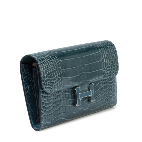 Hermès Constance Wallet with gold hardware and signature design, showcasing sleek leather material and compact style.