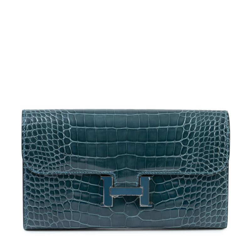 Hermès Constance Wallet in leather with gold hardware, featuring multiple card slots and a sleek, compact design.