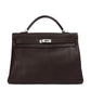 Hermès Kelly 40 Chocolate Brown top handle bag with structured design and gold hardware, elegant and luxurious accessory.