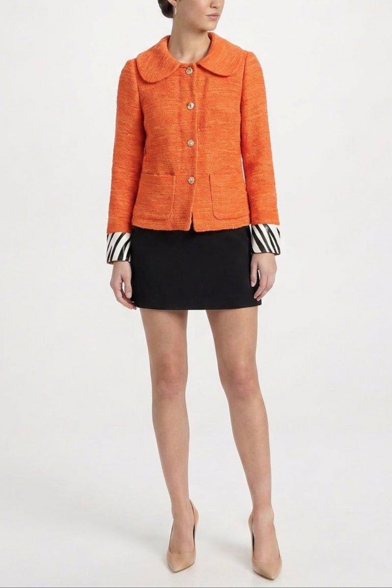 Orange textured blazer with zebra print cuffs by Dolce & Gabbana, stylish tailored jacket with bold pattern accents.