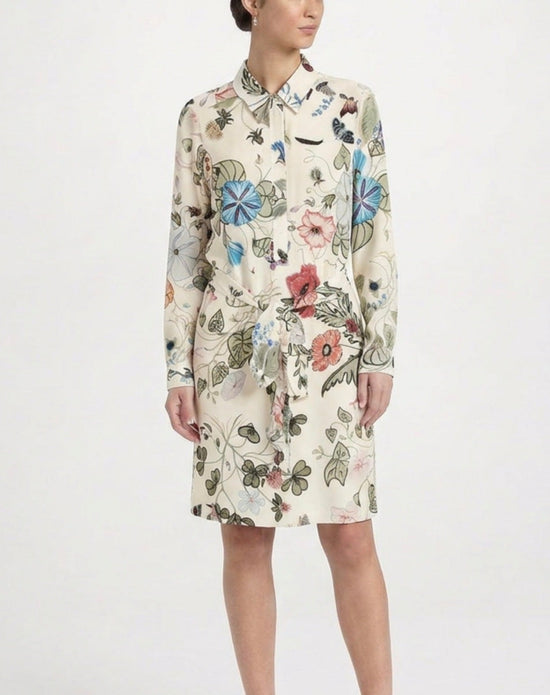 Gucci floral silk shirt dress with long sleeves, button front, and vibrant floral pattern on smooth silk fabric.