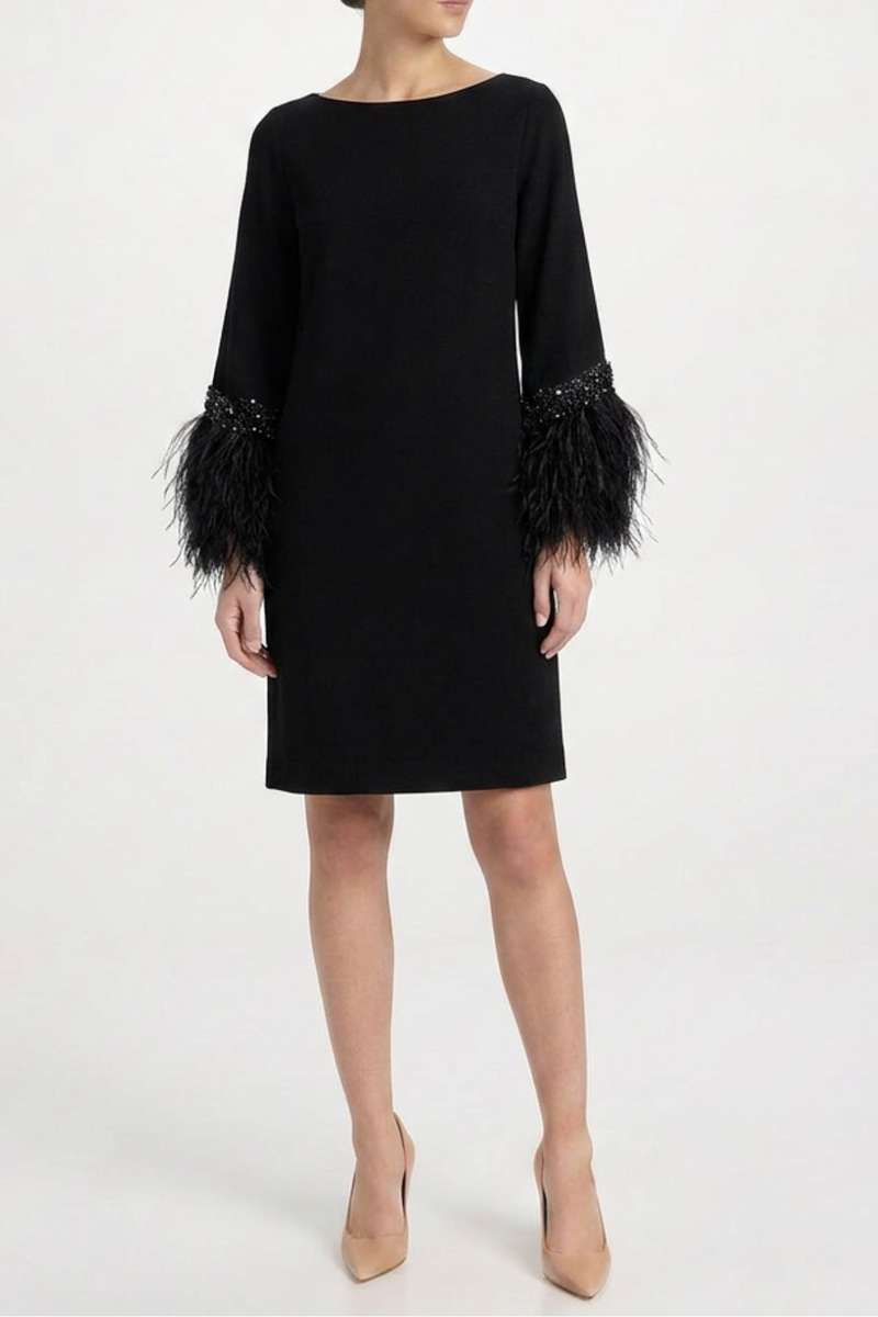 Elegant feather dress by Valentino featuring flowing fabric and intricate feather details, perfect for formal occasions.