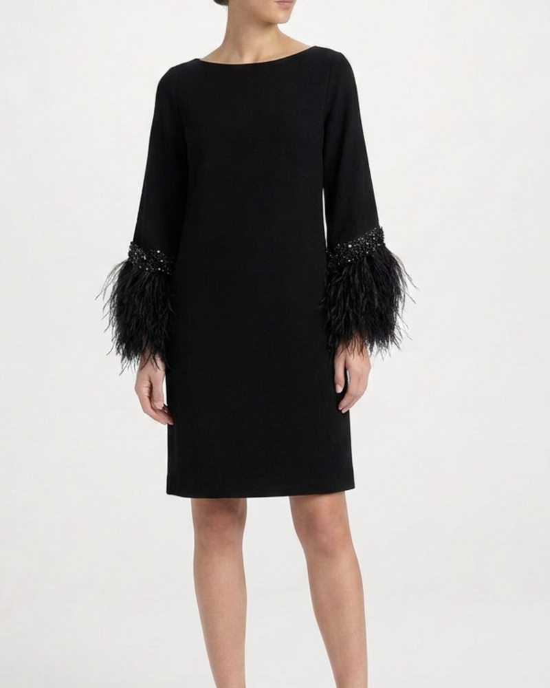 Elegant feather dress by Valentino featuring flowing fabric and intricate feather details, perfect for formal occasions.