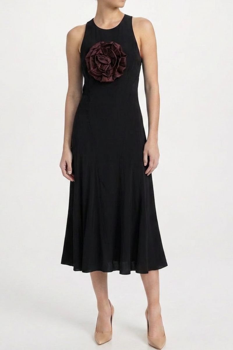 Black silk midi dress with appliqué detail from Saint Laurent, showcasing elegant design and flowing silhouette.