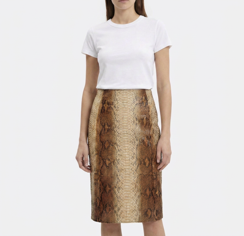 Beige leather Prada A-line skirt displayed on a hanger, showcasing smooth texture and classic silhouette.