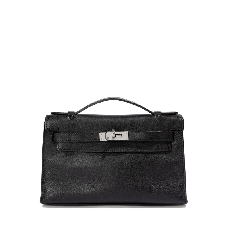 Hermès Kelly Pochette in black Swift leather with top handle, showcasing elegant craftsmanship and sleek design.