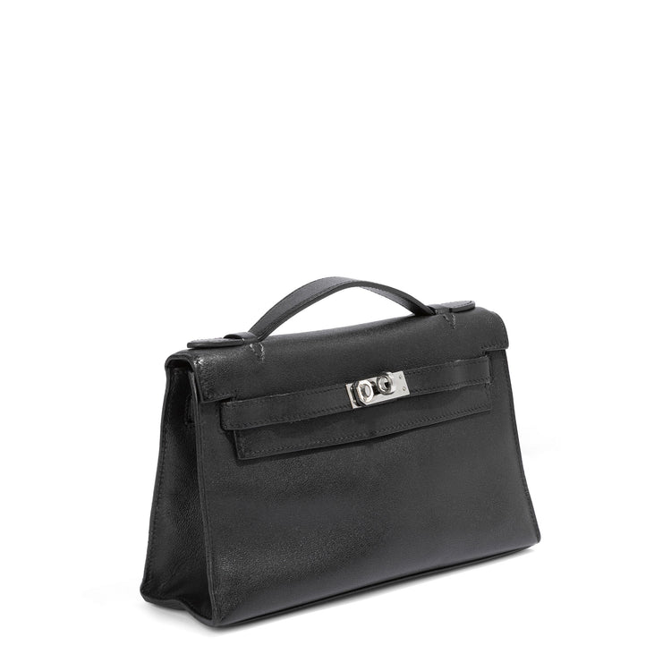 Hermès Kelly Pochette in black swift leather, compact handbag with gold hardware, elegant and luxurious design.