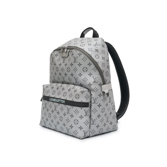 Louis Vuitton Kim Jones Apollo Monogram Reflect Backpack from Spring/Summer 2018 in grey reflective Monogram canvas with black trim, top handle and front zip pocket.