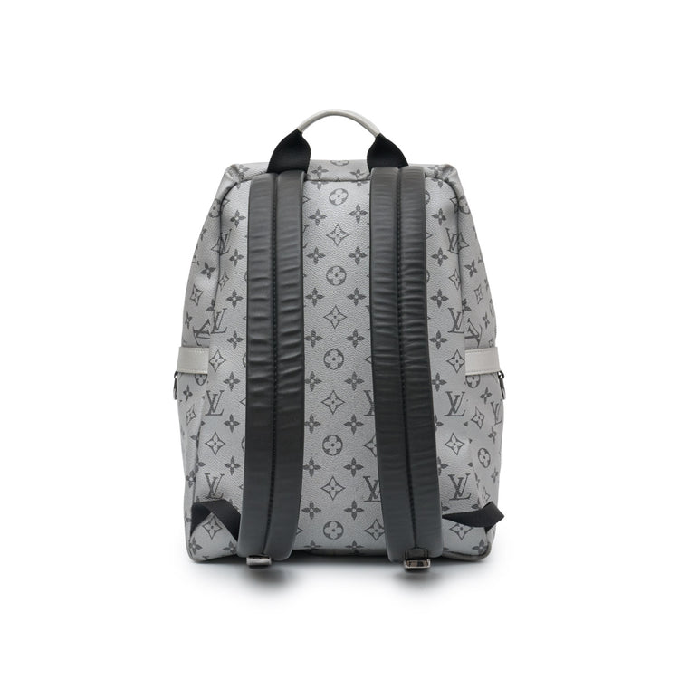 Louis Vuitton Kim Jones Apollo Monogram Reflect Backpack from Spring/Summer 2018 in grey reflective Monogram canvas with black trim, top handle and front zip pocket.