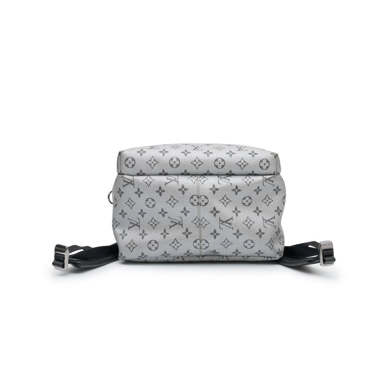 Louis Vuitton Kim Jones Apollo Monogram Reflect Backpack from Spring/Summer 2018 in grey reflective Monogram canvas with black trim, top handle and front zip pocket.