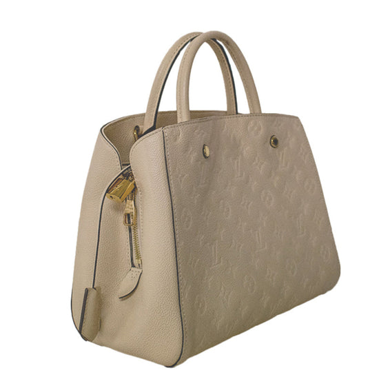 Louis Vuitton Montaigne beige leather handbag with embossed Monogram pattern, structured silhouette, dual top handles and gold-tone hardware.