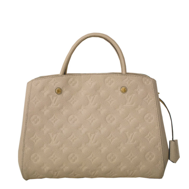Louis Vuitton Montaigne beige leather top handle handbag with gold hardware and structured design.