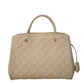 Louis Vuitton Montaigne beige leather top handle handbag with gold hardware and structured design.