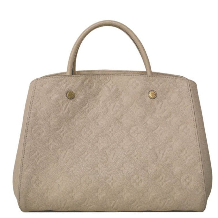 Louis Vuitton Montaigne beige leather handbag with embossed Monogram pattern, structured silhouette, dual top handles and gold-tone hardware.