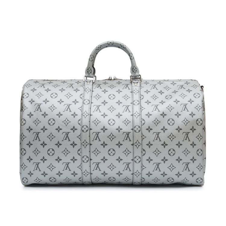 Louis Vuitton Metallic Monogram Keepall Bandoulière 50 in silver Monogram canvas with rolled top handles, silver-tone hardware, top zip closure and matching luggage tag.
