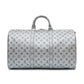 Louis Vuitton Metallic Monogram Keepall Bandoulière 50 in silver Monogram canvas with rolled top handles, silver-tone hardware, top zip closure and matching luggage tag.